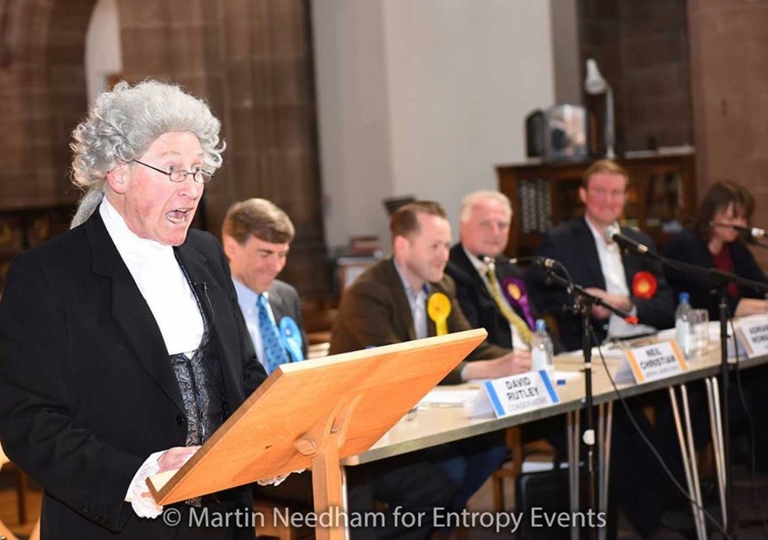 Playing Charles Roe moderating general electionHustings